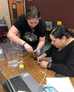 Teachers working together to code and build an automated watering system