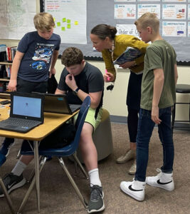 Hockinson teacher Hollie Rose helps students debug some code.